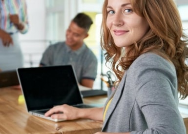 TasklyHub Featured Blog Image of Business Woman Turning Around From Desk